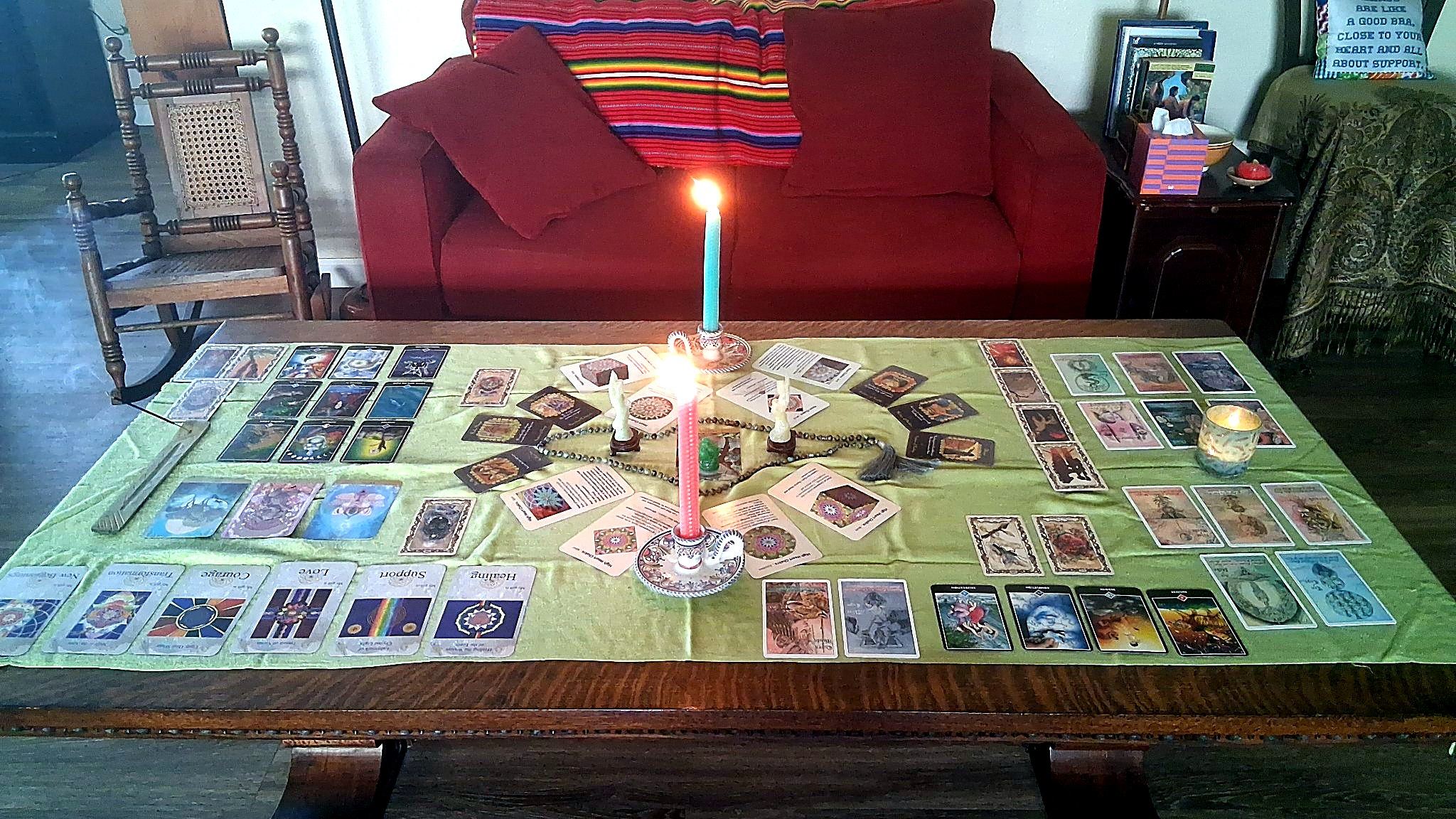 One of Christine's personalized altars, with candles, statues and cards laid out on a green cloth